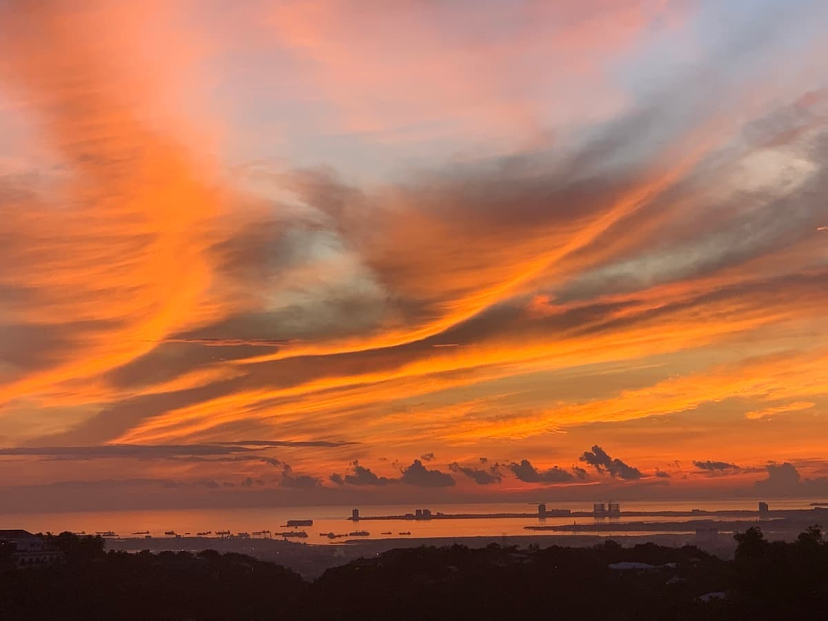 A burning orange sunset over the bay from Busay