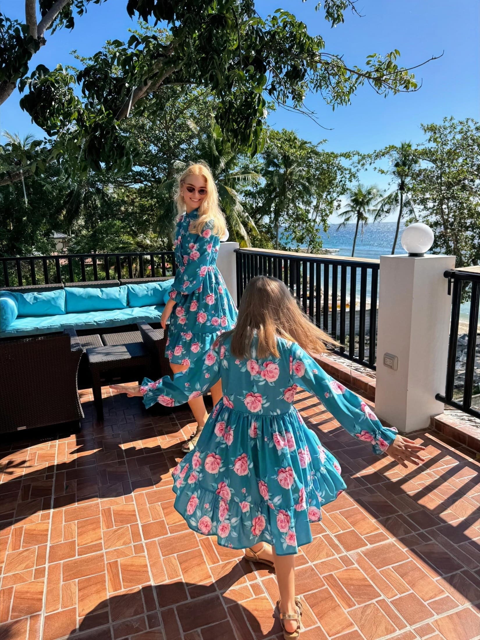 Guests in floral dresses on the G Bistro sea terrace