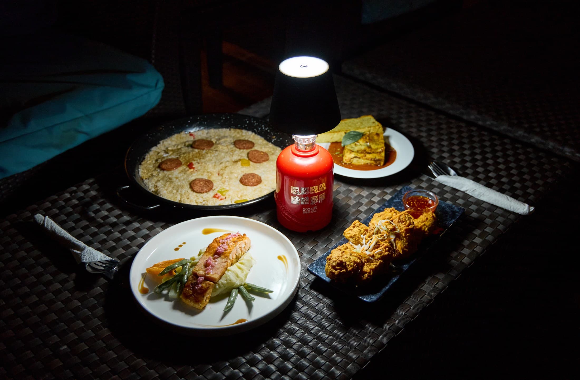 A candlelit G Bistro table with shared dishes at night