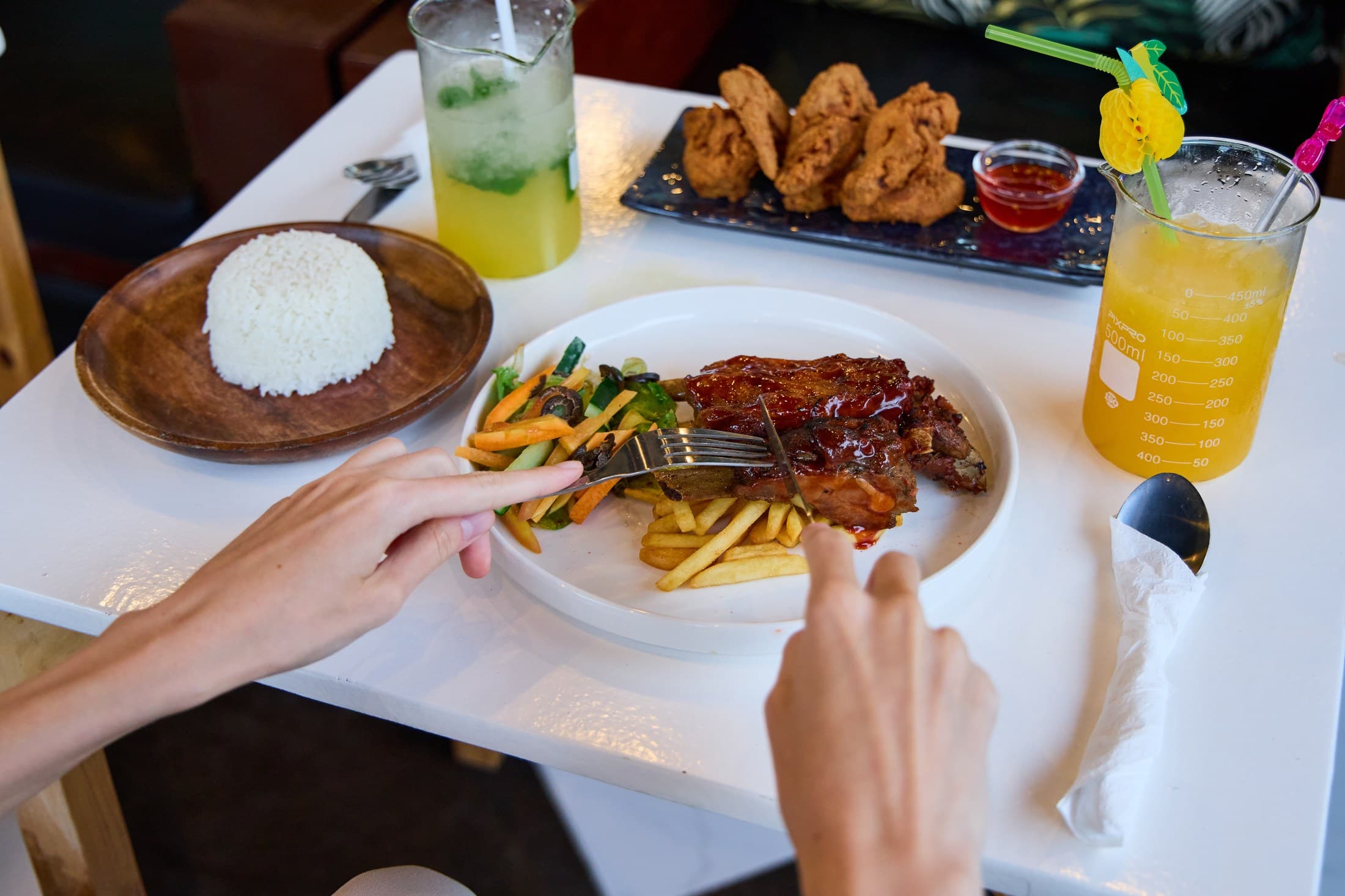 Food and tropical drinks on a G Bistro table