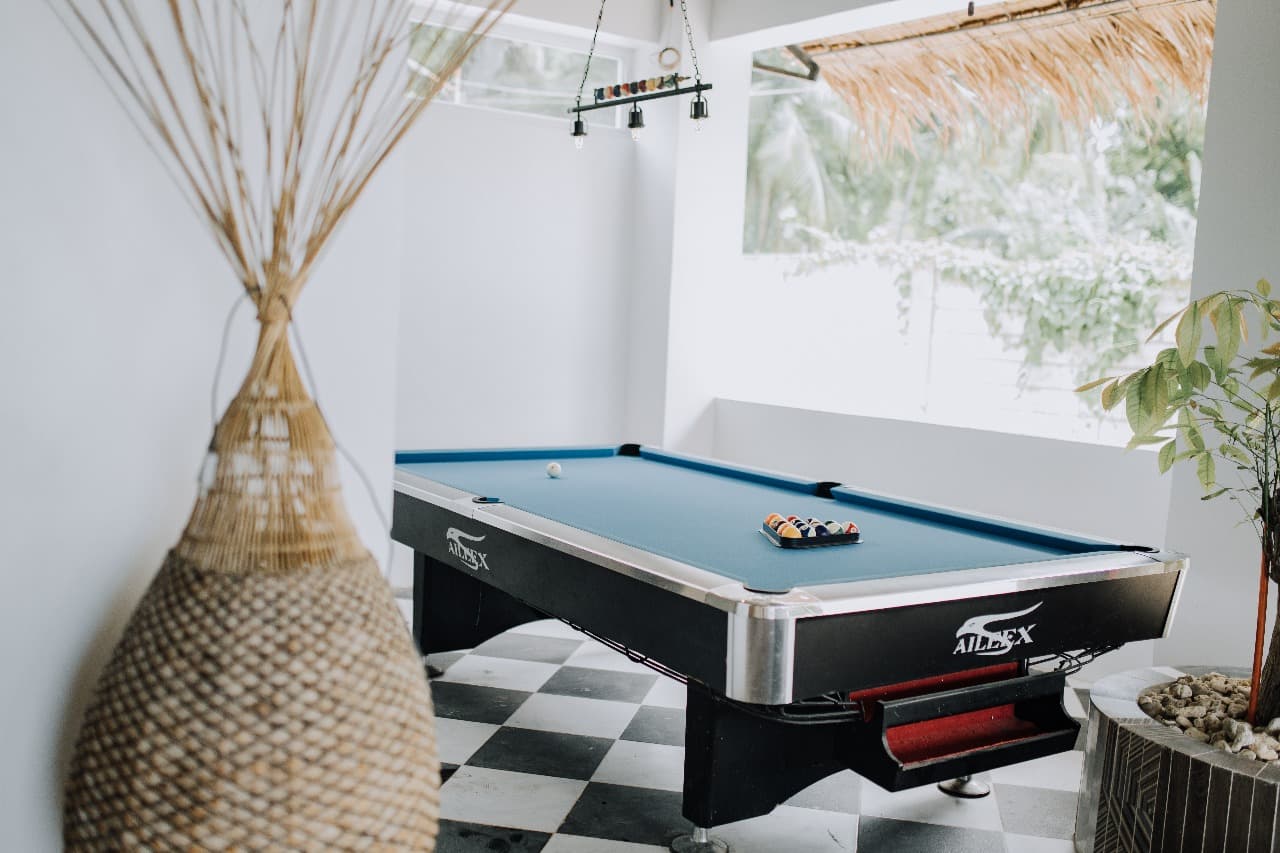The G Boutique game room with billiards and warm lights