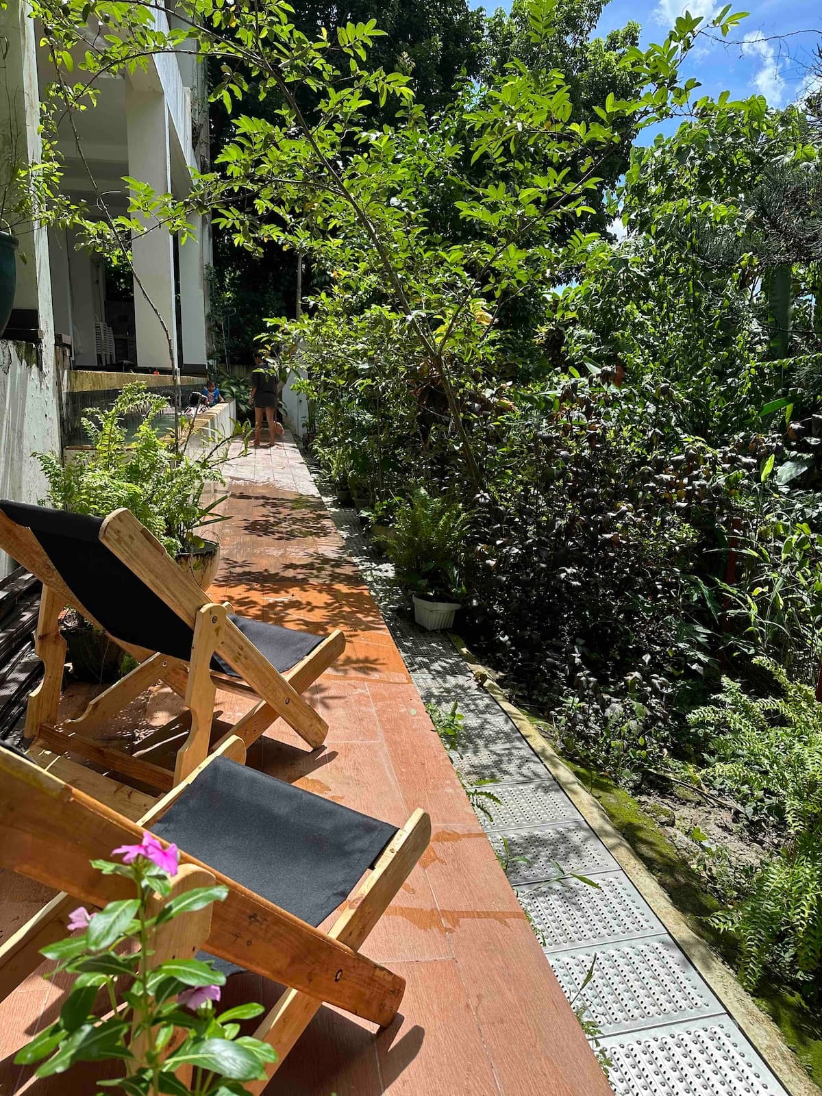 A timber deck looking out over the green Busay valley